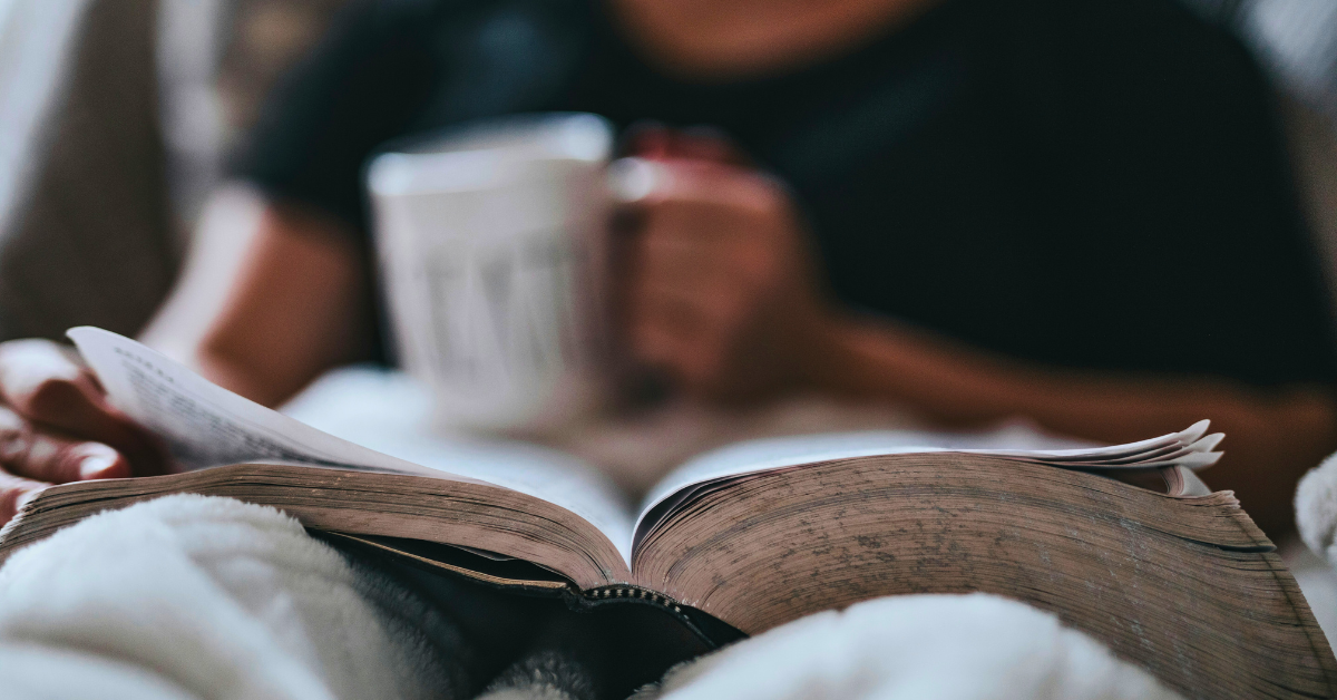 woman with open Bible and coffee mug